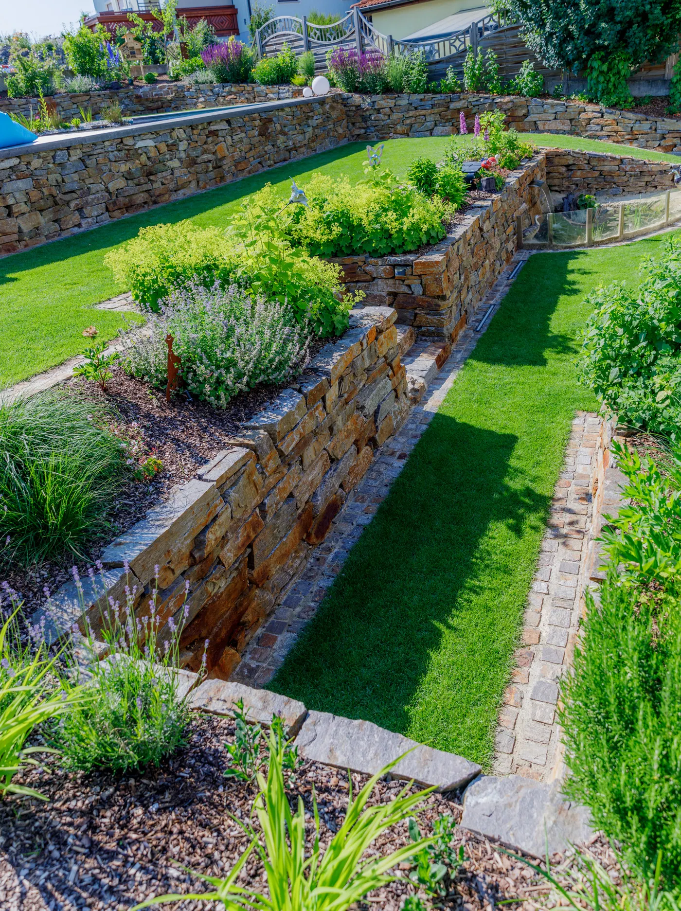Lavendel blüht vor der Natursteinmauer der Gartenterrassen
